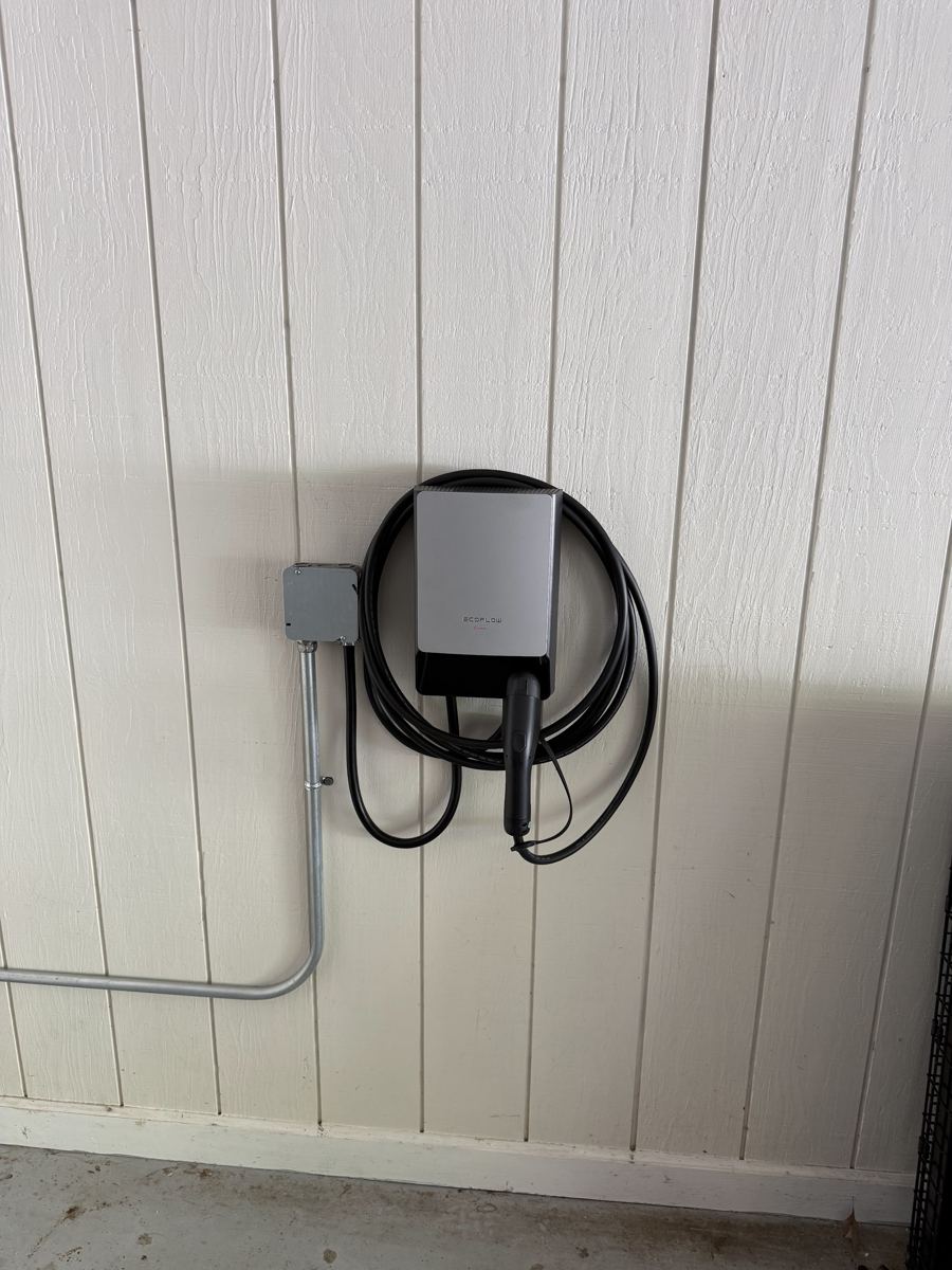Home EV charger with conduit run in a garage